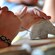 A child’s hands using a carving tool to sculpt a work of art out of soapstone